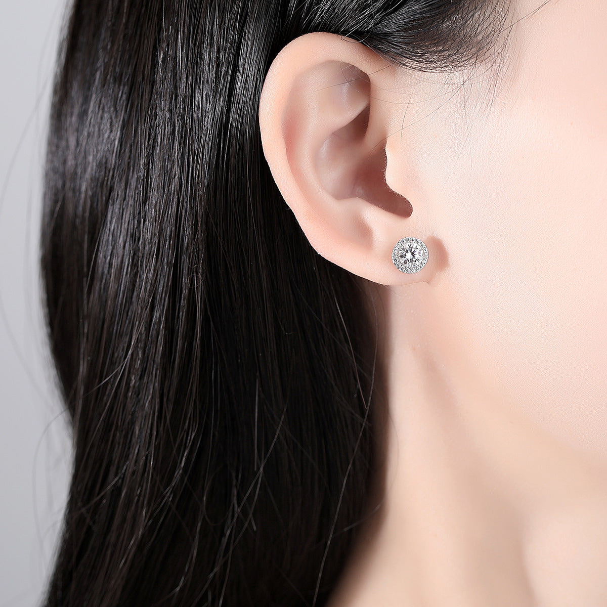 Close-up of an ear with a stud earring in a person's ear.